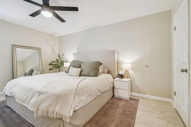 a bedroom with a bed and painting on the wall