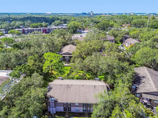 an aerial view of a house with yard and outdoor seating