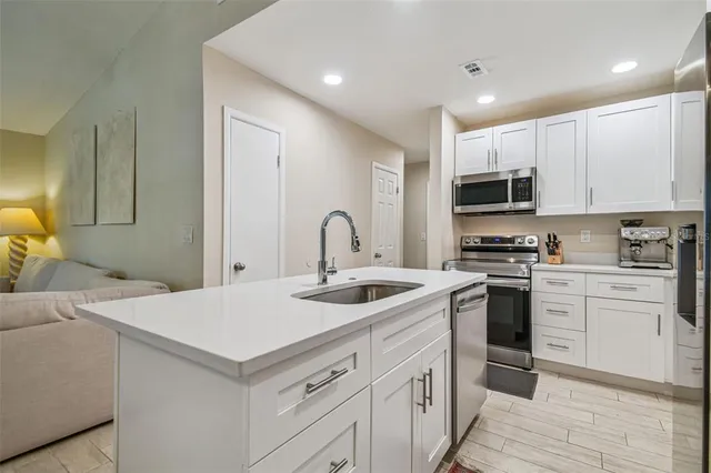 a kitchen with a sink stove and cabinets