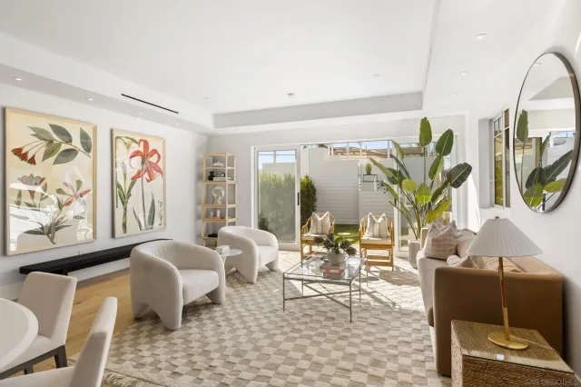 a living room with furniture a window and a flat screen tv