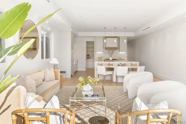 a living room with furniture and a chandelier