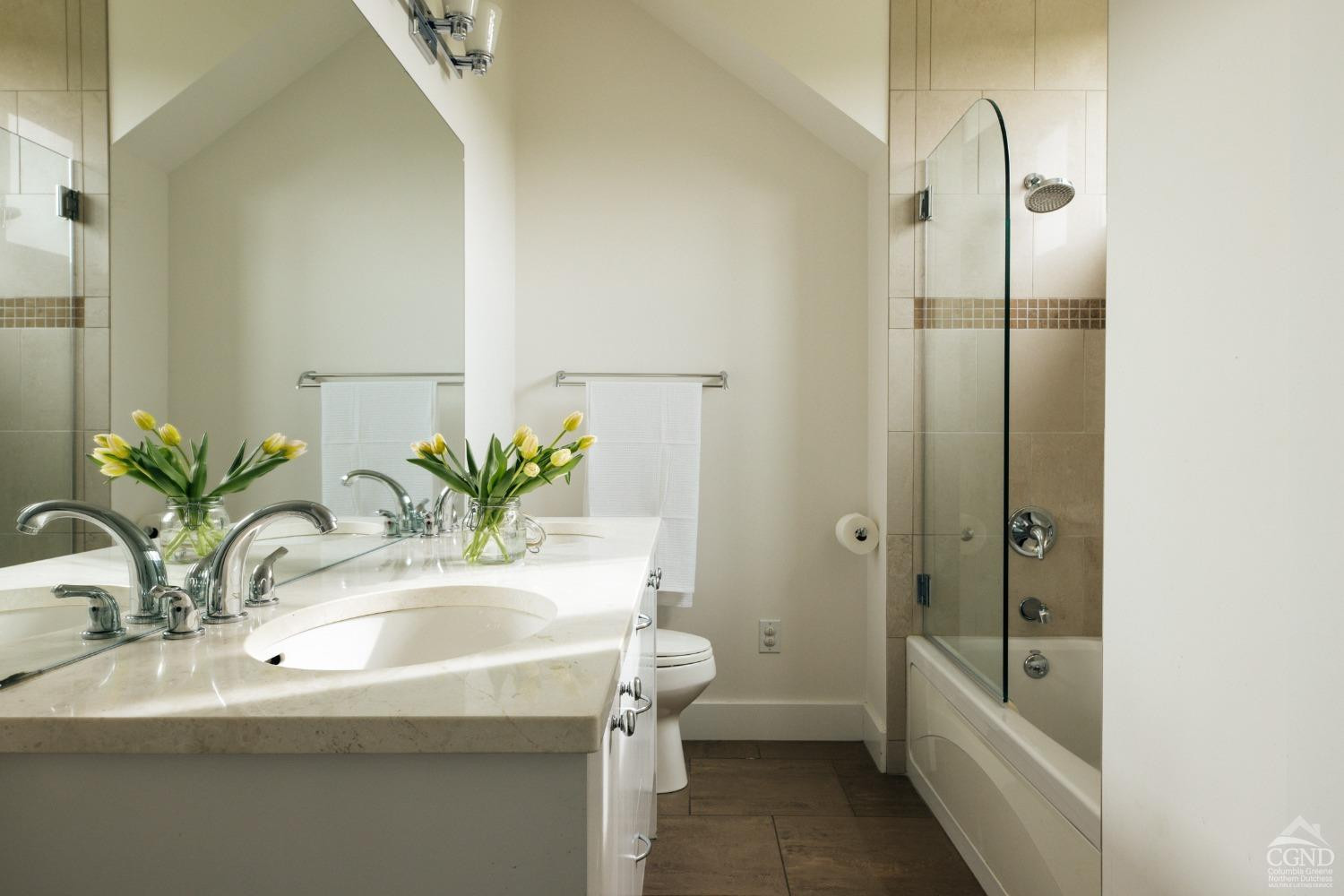128 Robin Lane Copake, NY 12516 - Photo 23 of 33 a bathroom with a granite countertop sink a toilet and a bathtub