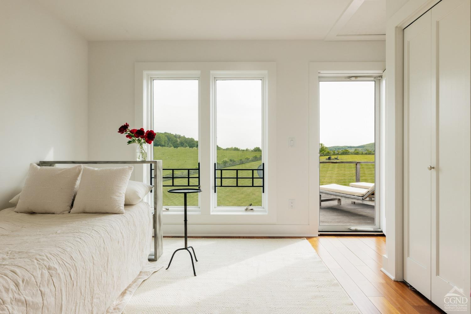 128 Robin Lane Copake, NY 12516 - Photo 28 of 33 a bedroom with a bed and a large window