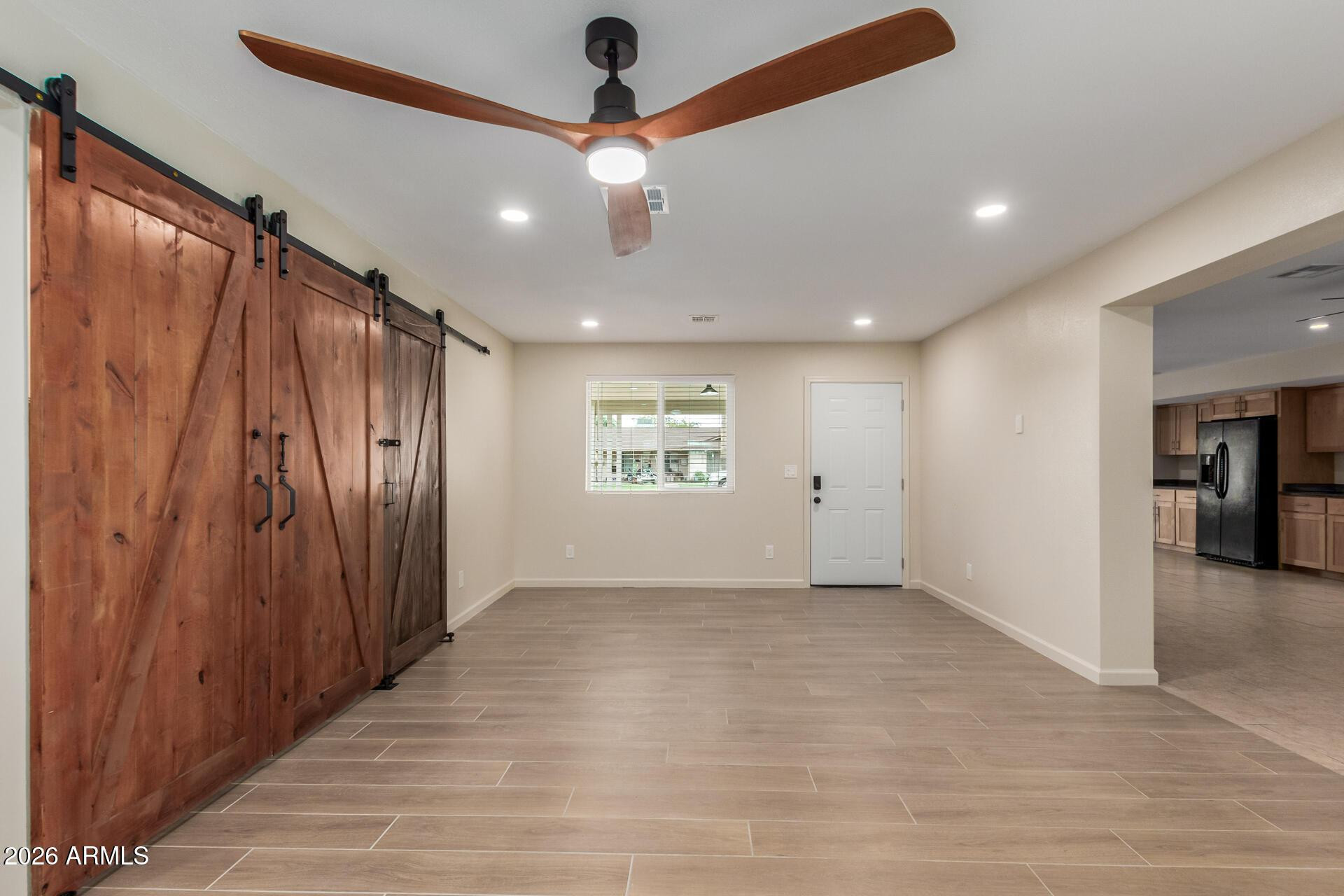 1628 East Del Rio Drive Tempe, AZ 85282 - Photo 2 of 32 an empty room with wooden floor hallway and closet area