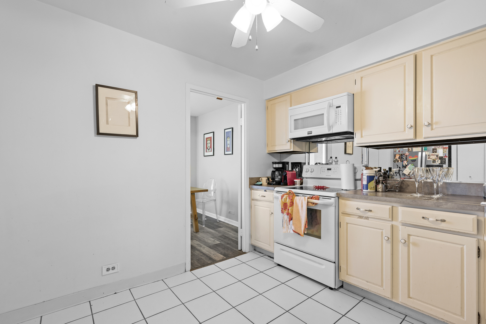6033 North Sheridan Road, Unit 24B Chicago, IL 60660 - Photo 17 of 36 a kitchen with white cabinets a sink and dishwasher