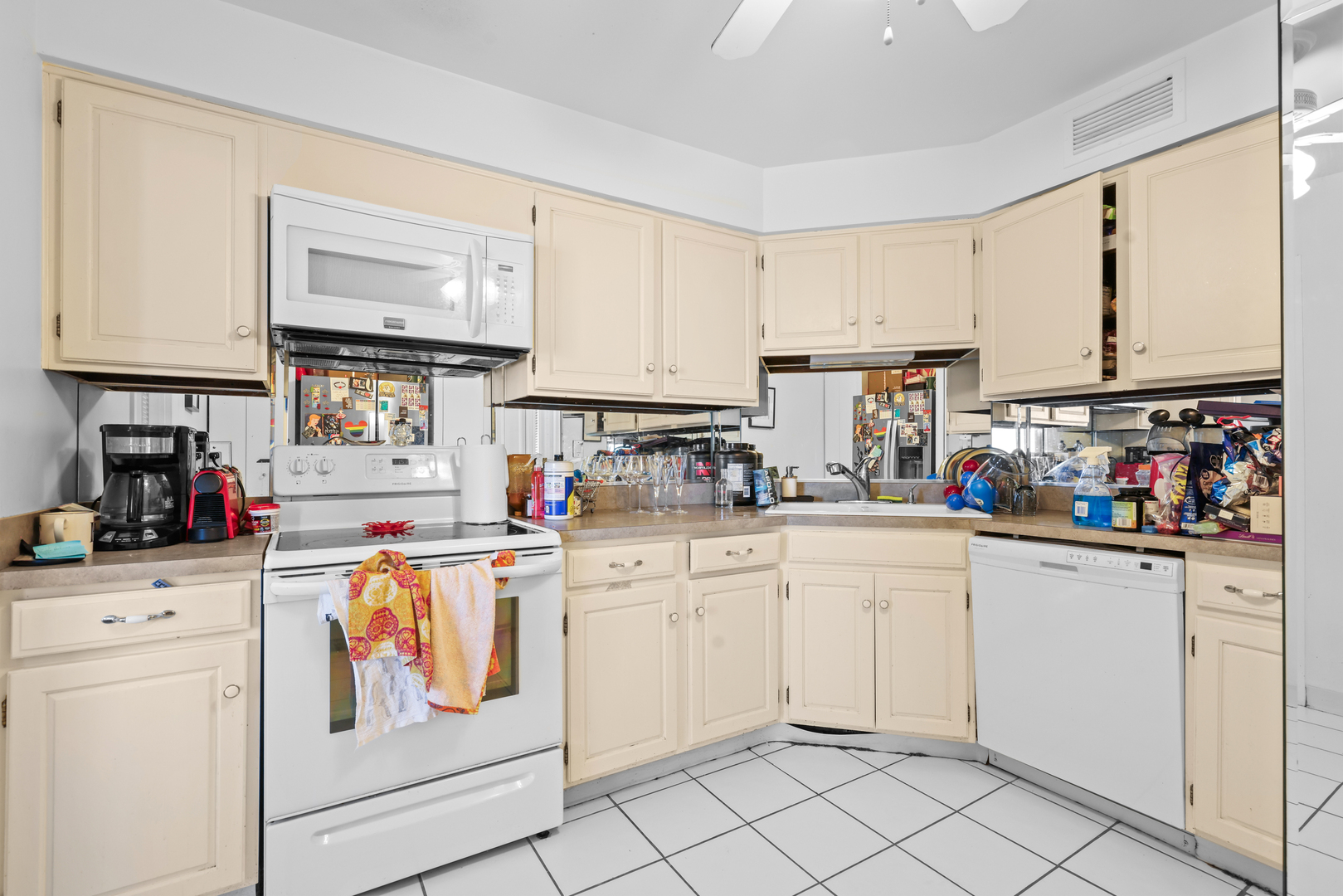 6033 North Sheridan Road, Unit 24B Chicago, IL 60660 - Photo 18 of 36 a kitchen with white cabinets and white appliances