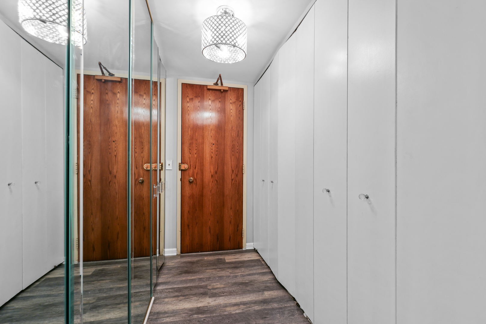 6033 North Sheridan Road, Unit 24B Chicago, IL 60660 - Photo 9 of 36 a view of a hallway with wooden floor