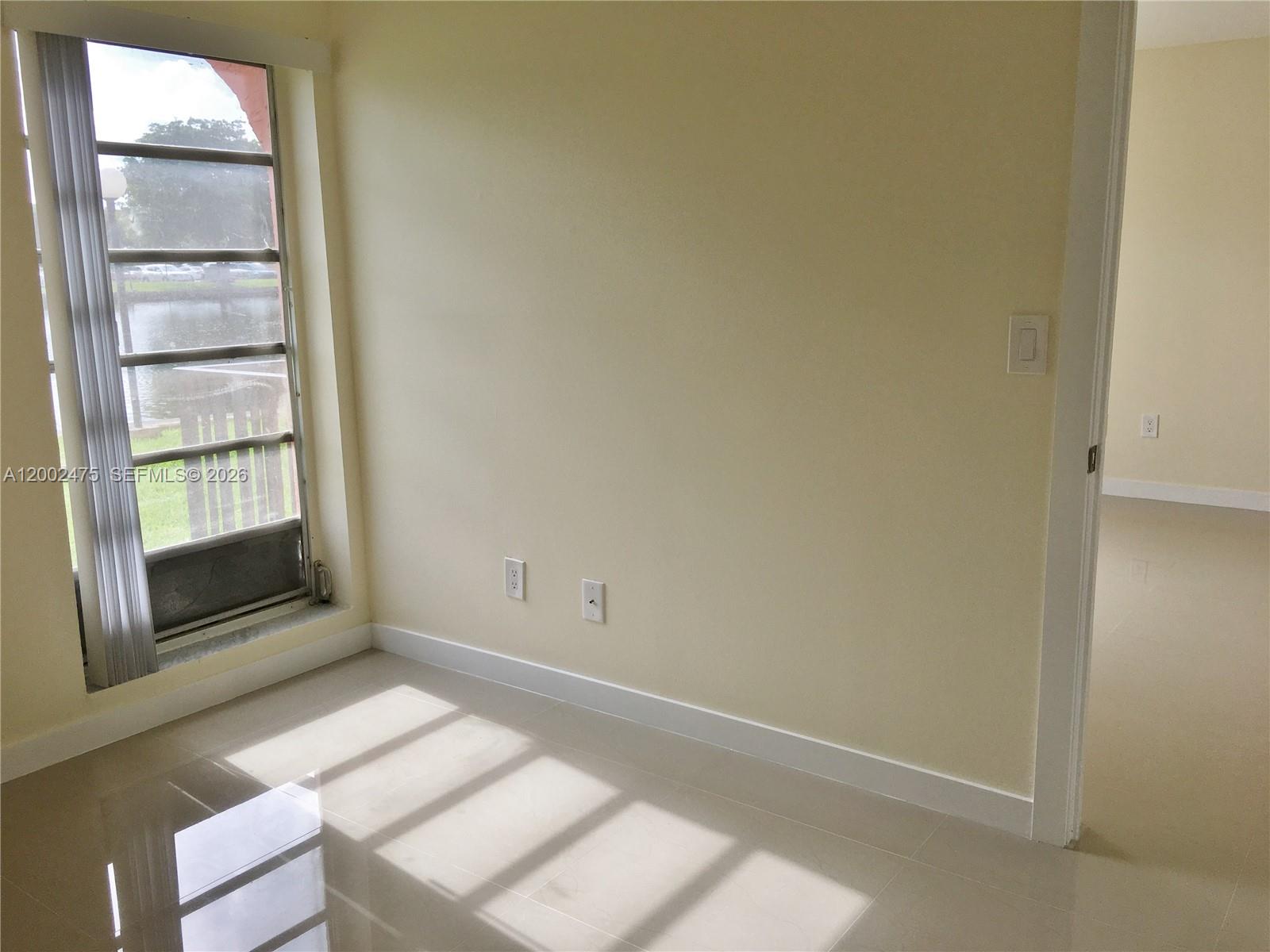 4709 Northwest 7th Street, Unit 1079 Miami, FL 33126 - Photo 11 of 28 an empty room with windows