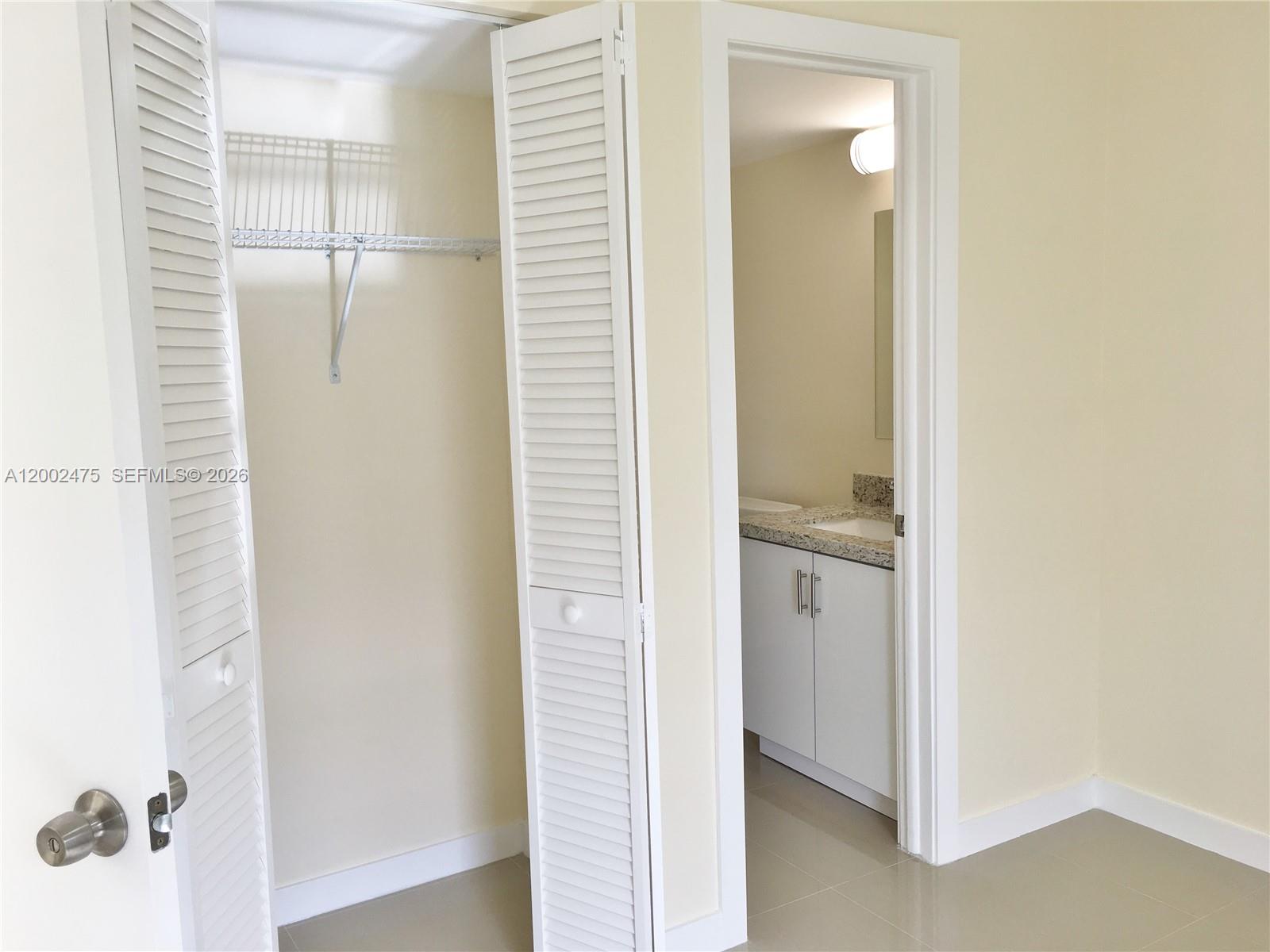 4709 Northwest 7th Street, Unit 1079 Miami, FL 33126 - Photo 12 of 28 a bathroom with a shower