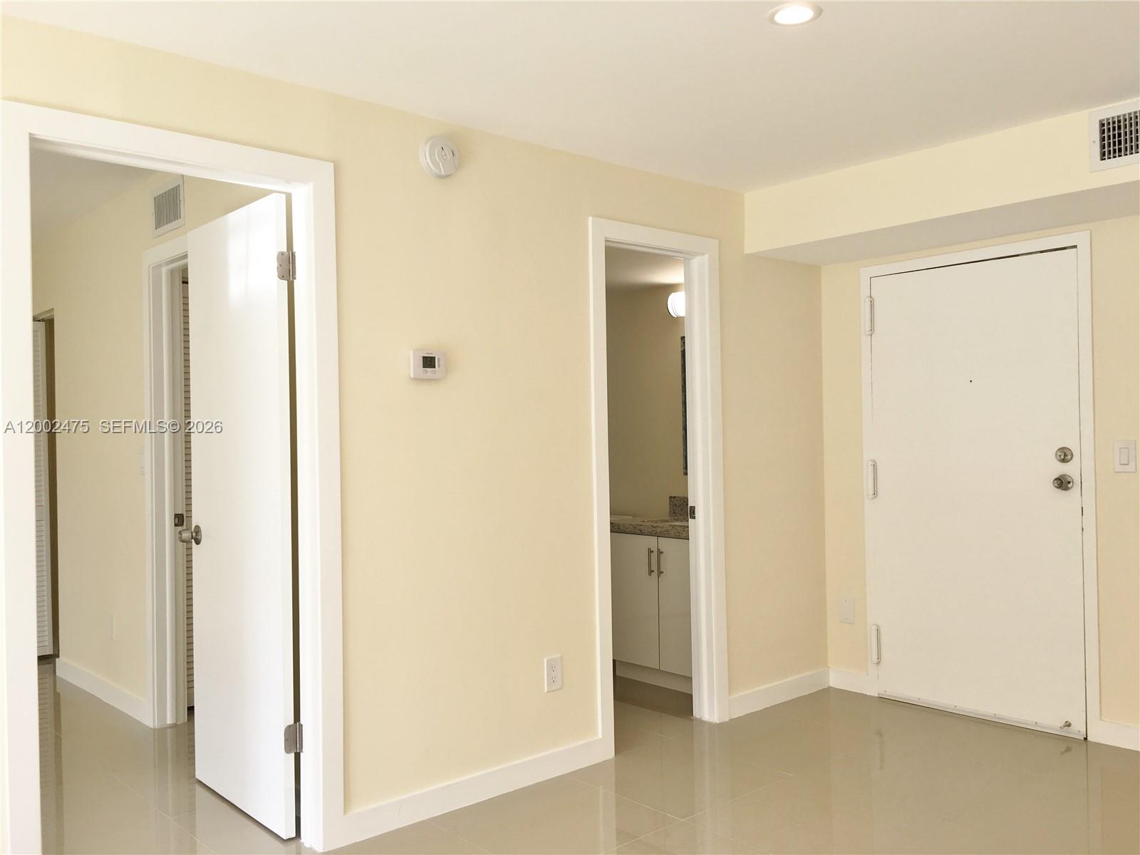 4709 Northwest 7th Street, Unit 1079 Miami, FL 33126 - Photo 15 of 28 a view of a bathroom with a glass door