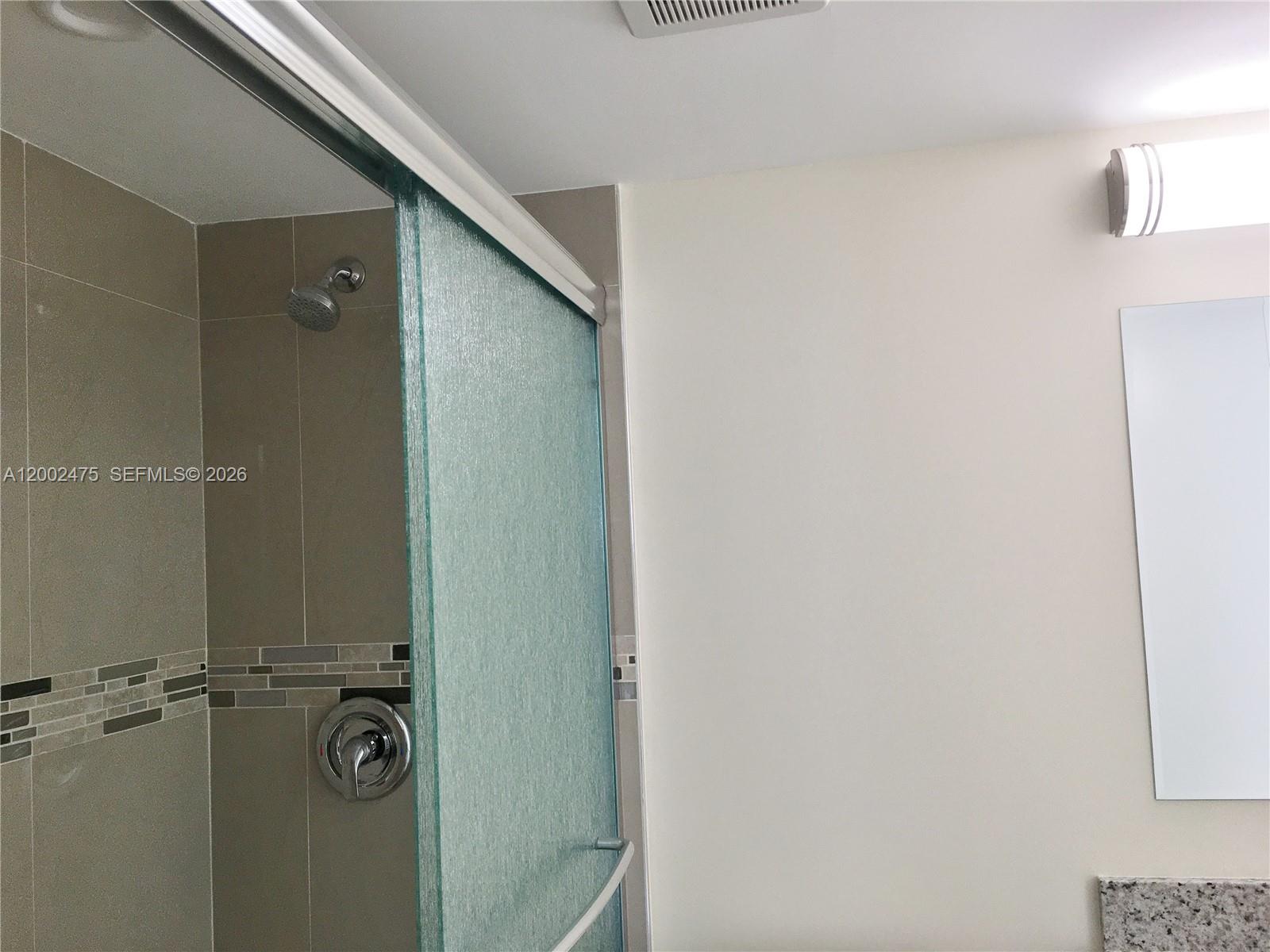 4709 Northwest 7th Street, Unit 1079 Miami, FL 33126 - Photo 16 of 28 a bathroom with a shower