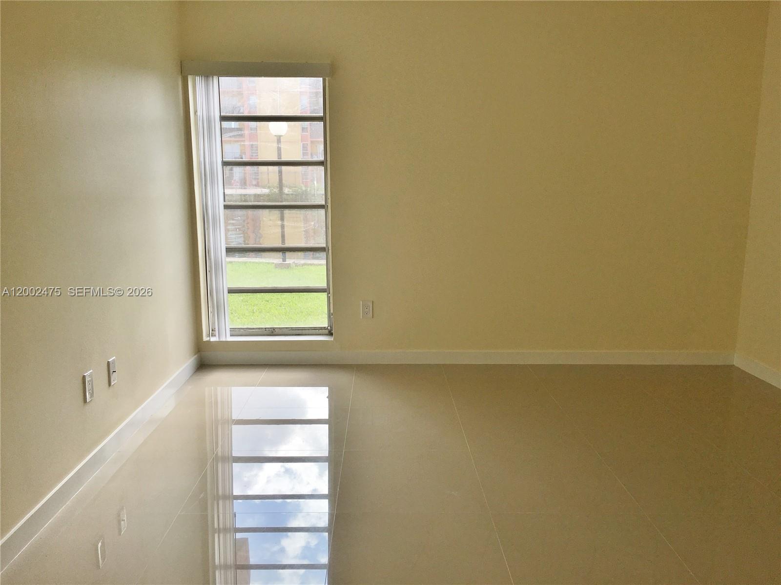 4709 Northwest 7th Street, Unit 1079 Miami, FL 33126 - Photo 18 of 28 a view of an empty room with a window