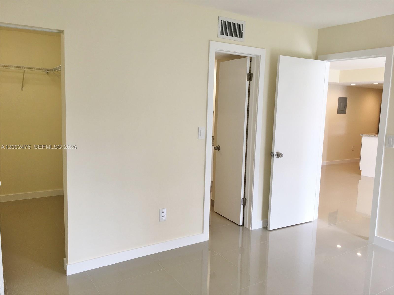 4709 Northwest 7th Street, Unit 1079 Miami, FL 33126 - Photo 19 of 28 a view of a bathroom with a glass door