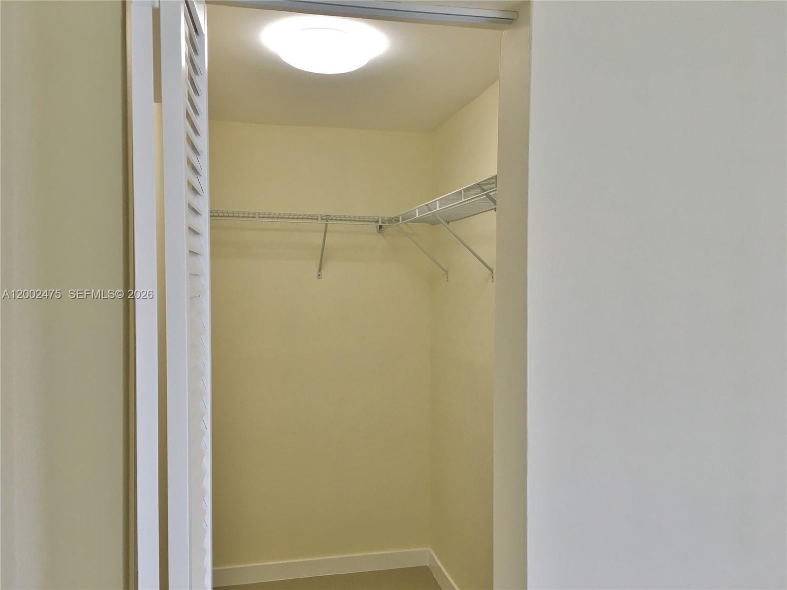 4709 Northwest 7th Street, Unit 1079 Miami, FL 33126 - Photo 20 of 28 a bathroom that has a glass shower door