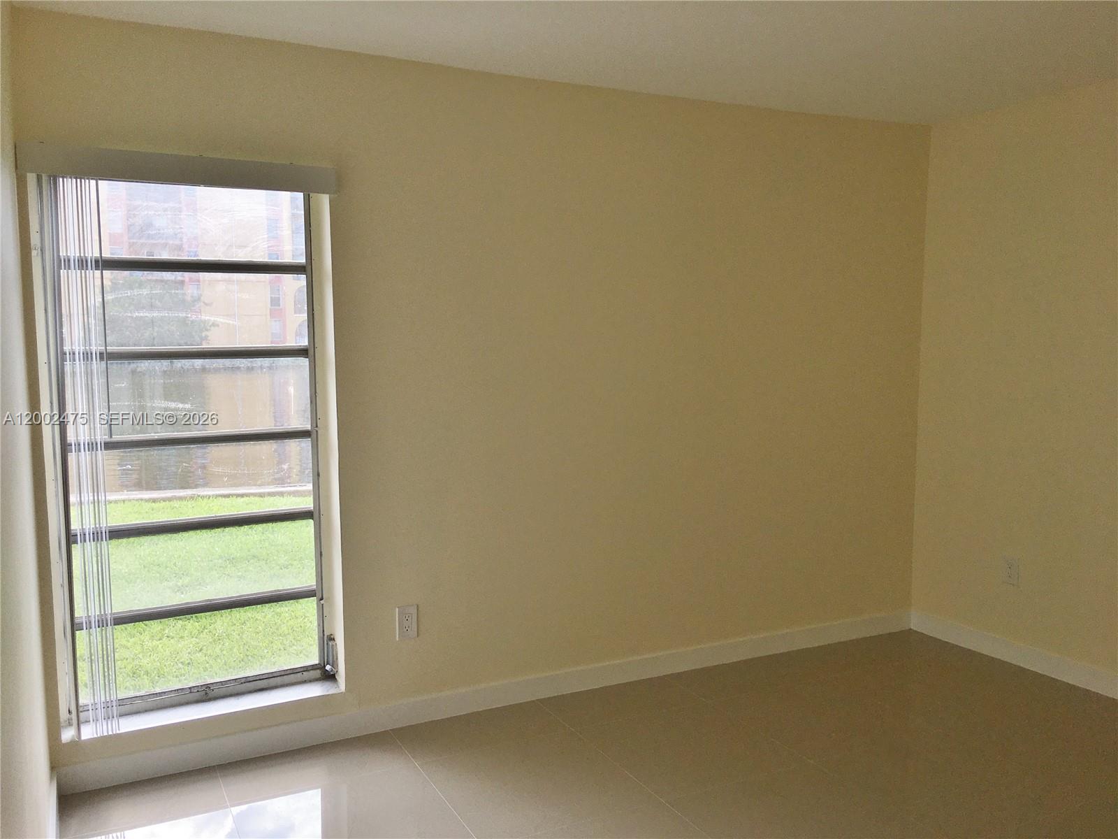 4709 Northwest 7th Street, Unit 1079 Miami, FL 33126 - Photo 21 of 28 a view of an empty room with a window
