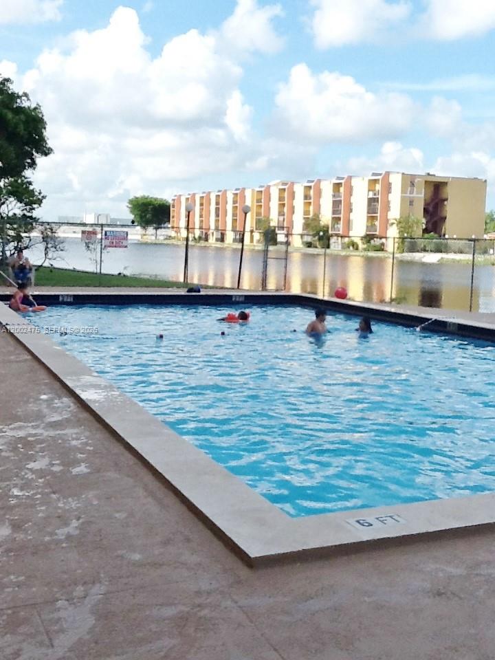 4709 Northwest 7th Street, Unit 1079 Miami, FL 33126 - Photo 25 of 28 a view of swimming pool with outdoor seating and city view