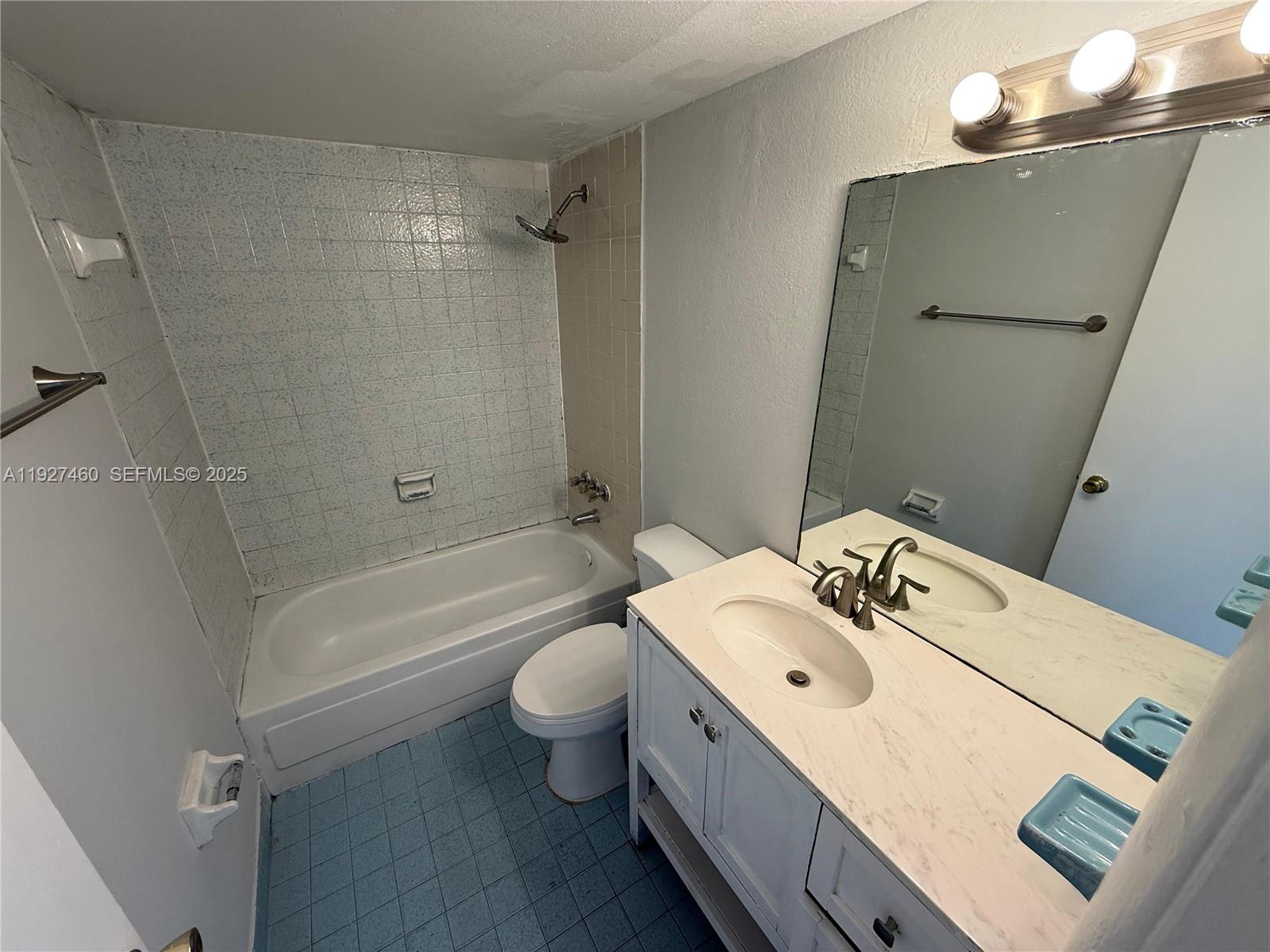 1900 West 68th Street, Unit G308 Hialeah, FL 33014 - Photo 7 of 10 a bathroom with a sink mirror toilet and bathtub