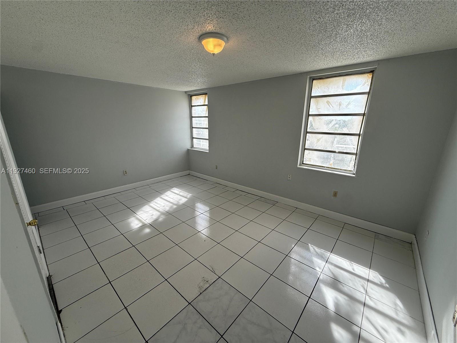 1900 West 68th Street, Unit G308 Hialeah, FL 33014 - Photo 8 of 10 a view of empty room with windows