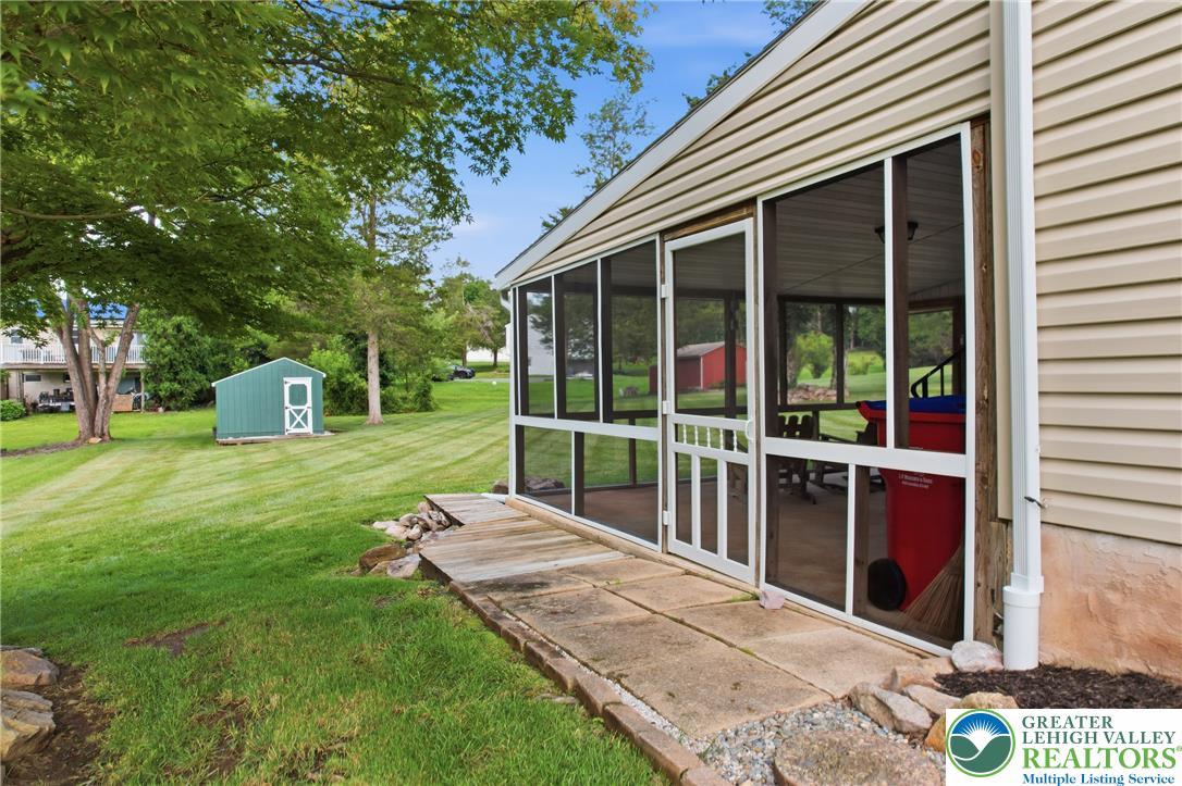 1385 Woodmere Road Pottstown, PA 19464 - Photo 50 of 57 A tranquil backyard setting features a practical storage shed and a charming screened porch.