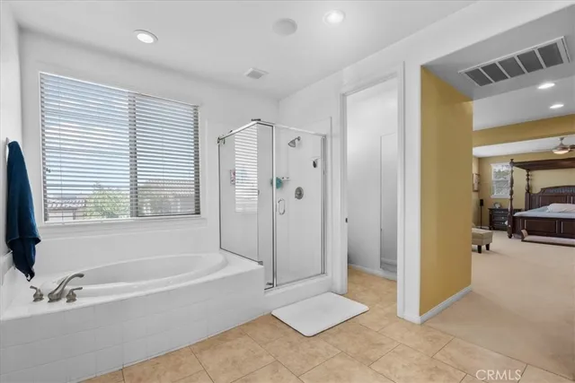 a bedroom with bed and a window