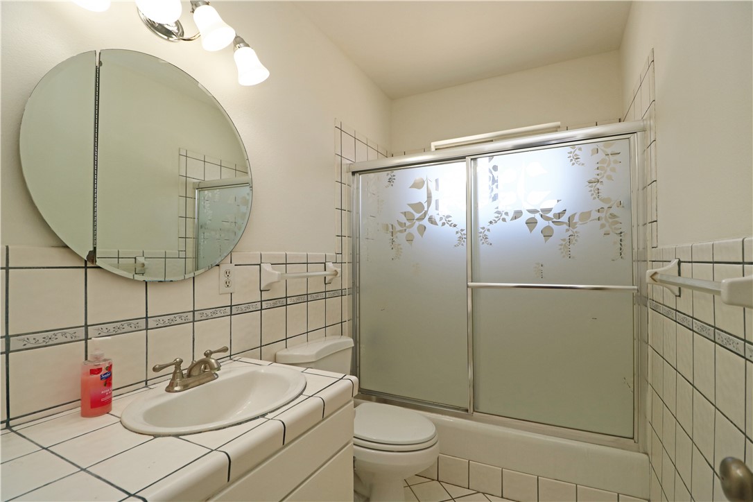 721 North Milford Road Orange, CA 92867 - Photo 16 of 38 Hall bathroom with tile counters and wainscot.