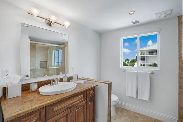 a bathroom with a tub a sink and a mirror