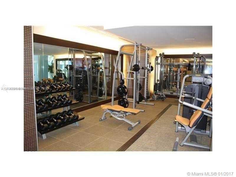 200 South Biscayne Boulevard, Unit 3903 Miami, FL 33131 - Photo 19 of 19 a room with gym equipment and a large window