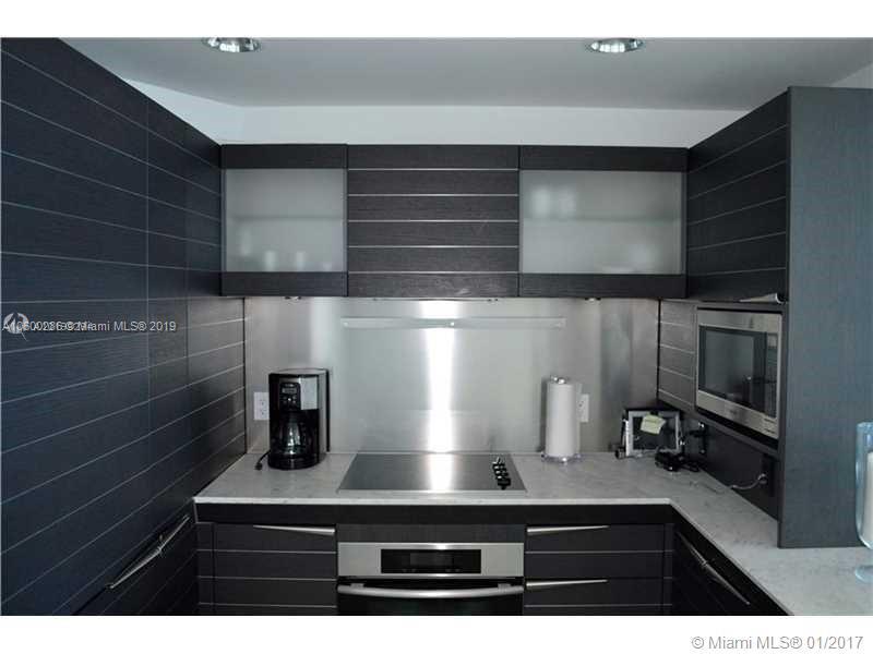 200 South Biscayne Boulevard, Unit 3903 Miami, FL 33131 - Photo 5 of 19 a kitchen with a refrigerator and a sink