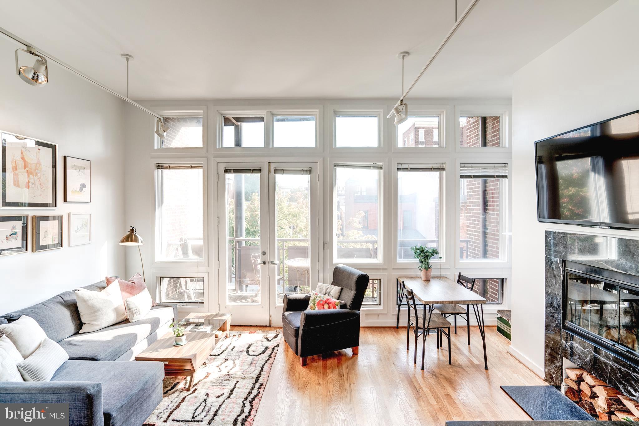 1527 Church Street Northwest, Unit A Washington, DC 20005 - Photo 2 of 31 Sun drenched living area, wood burning fireplace