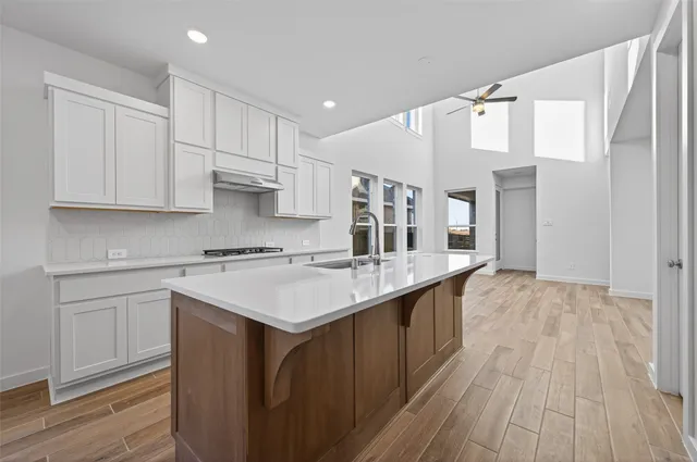 a kitchen with a sink stove and cabinets