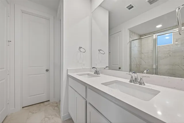 a bathroom with a sink double vanity and a mirror