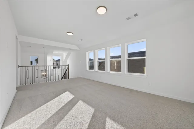 a view of a big room with windows and entryway