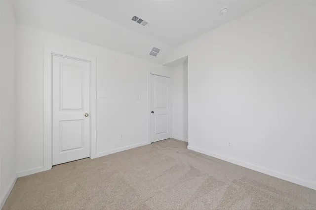 a view of backyard with wooden fence