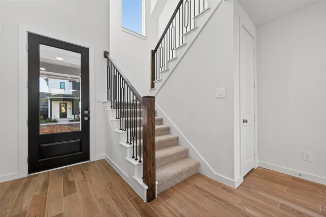 a view of entryway with wooden floor and stairs