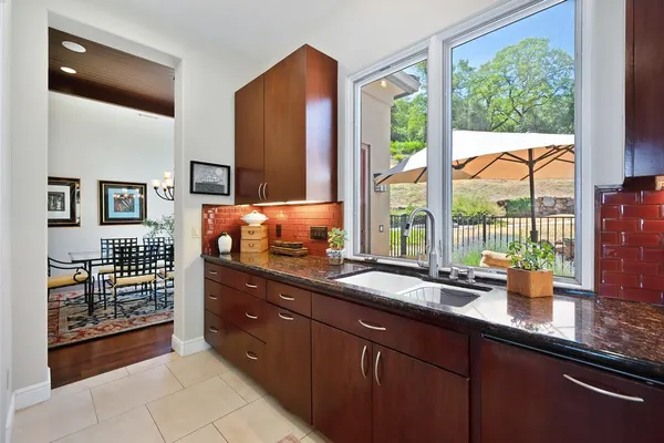 a living room with furniture hard wood floor and a chandelier