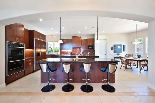 a living room with furniture a flat screen tv and a table