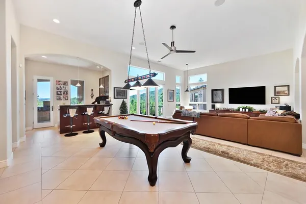 a white bath tub sitting in a bathroom next to a window