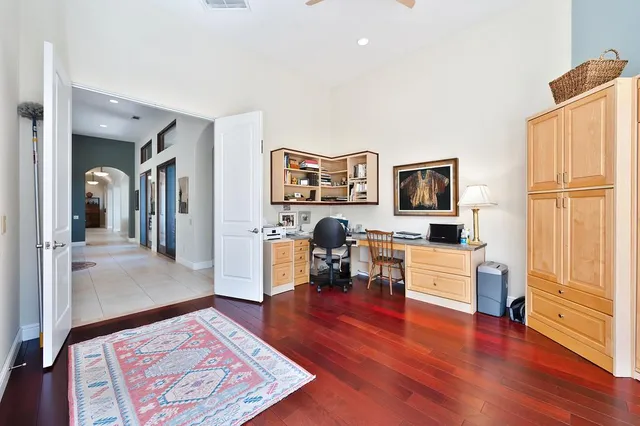 a view of a patio with table and chairs with wooden floor and fence