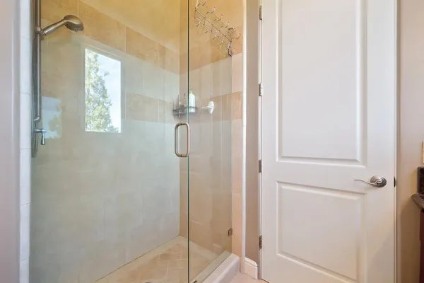 an aerial view of a house with outdoor space and trees all around