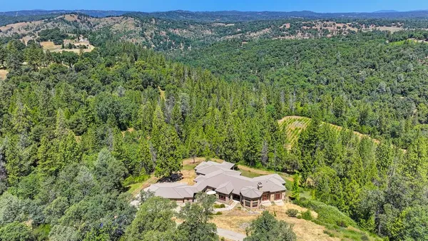 a dining room with furniture a chandelier and wooden floor