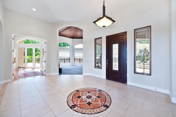 a kitchen with stainless steel appliances wooden cabinets a sink and a large window