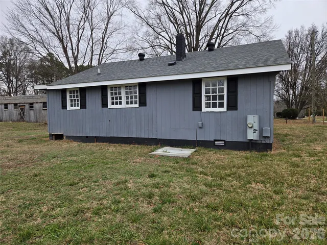 a outdoor view of house with backyard space