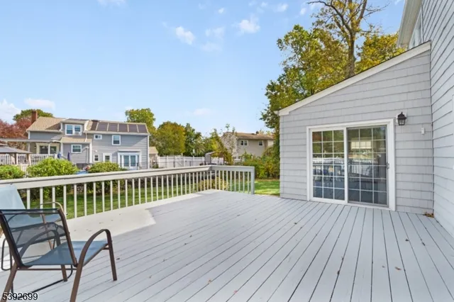 a view of a chair and table on the wooden deck