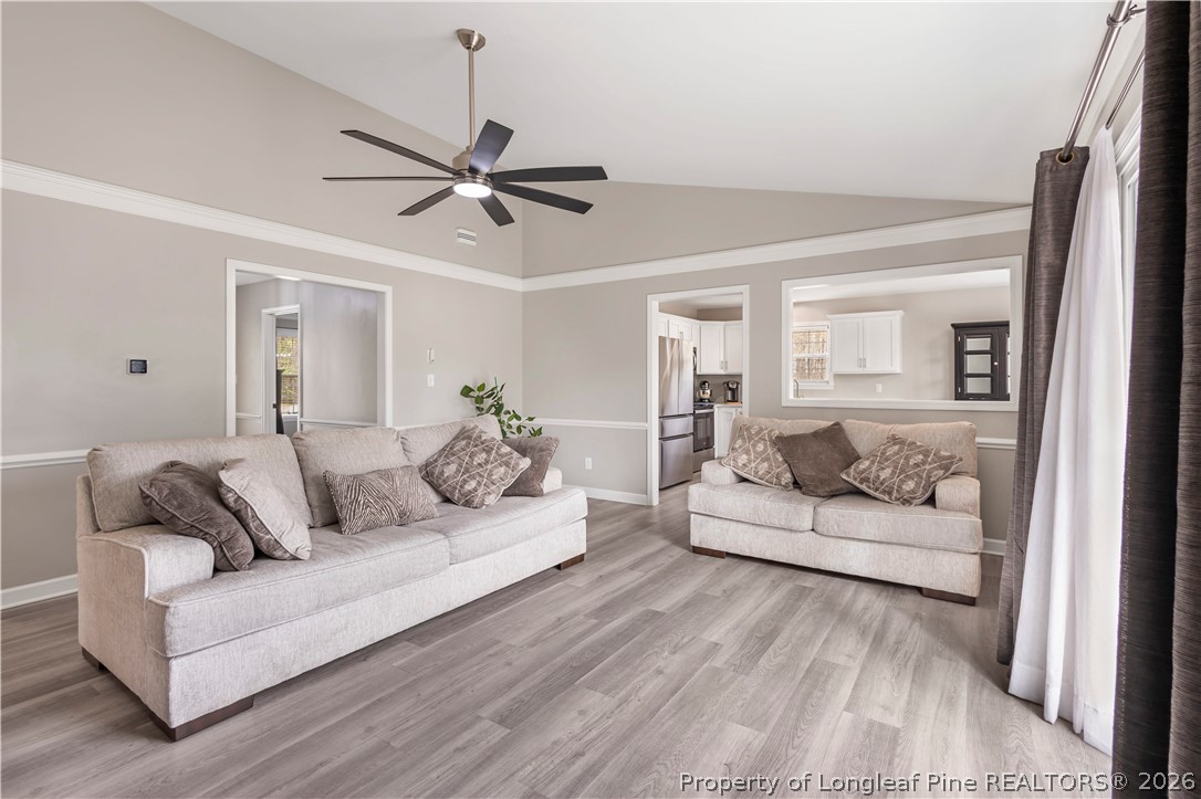 253 Farmstead Court Rockingham, NC 28379 - Photo 12 of 25 a living room with furniture and a wooden floor