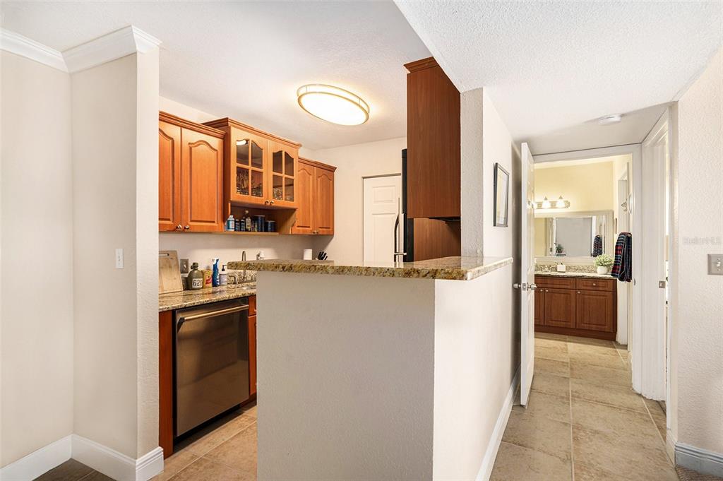 455 Alt 19, Unit 65 Palm Harbor, FL 34683 - Photo 8 of 16 a kitchen with stainless steel appliances granite countertop a refrigerator and a stove top oven