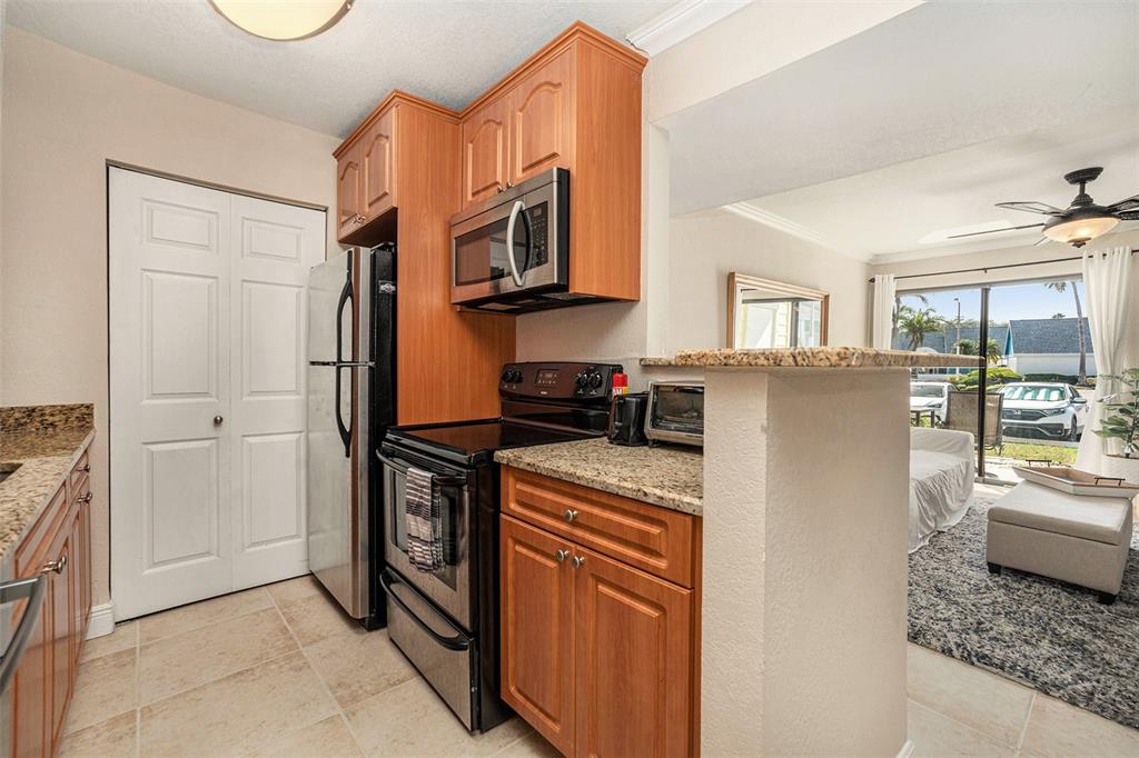 455 Alt 19, Unit 65 Palm Harbor, FL 34683 - Photo 10 of 16 a kitchen with stainless steel appliances granite countertop a refrigerator and a stove
