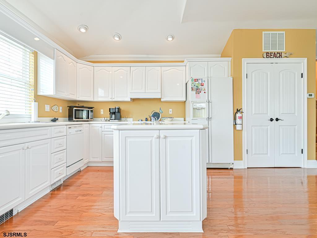 2304 Ocean Avenue Brigantine, NJ 08203 - Photo 11 of 27 a kitchen with stainless steel appliances a refrigerator sink and cabinets