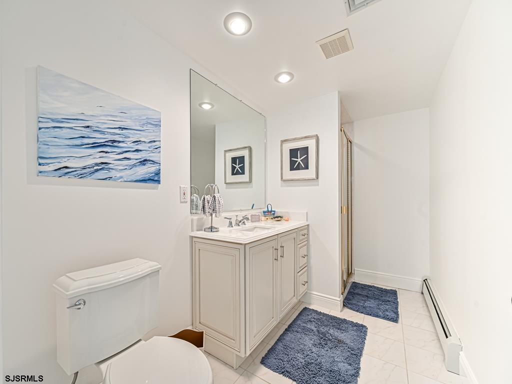 2304 Ocean Avenue Brigantine, NJ 08203 - Photo 18 of 27 a bathroom with a sink and mirror with toilet