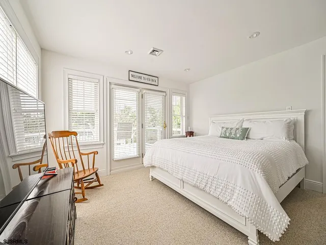 a bedroom with a bed and a large window with outer view