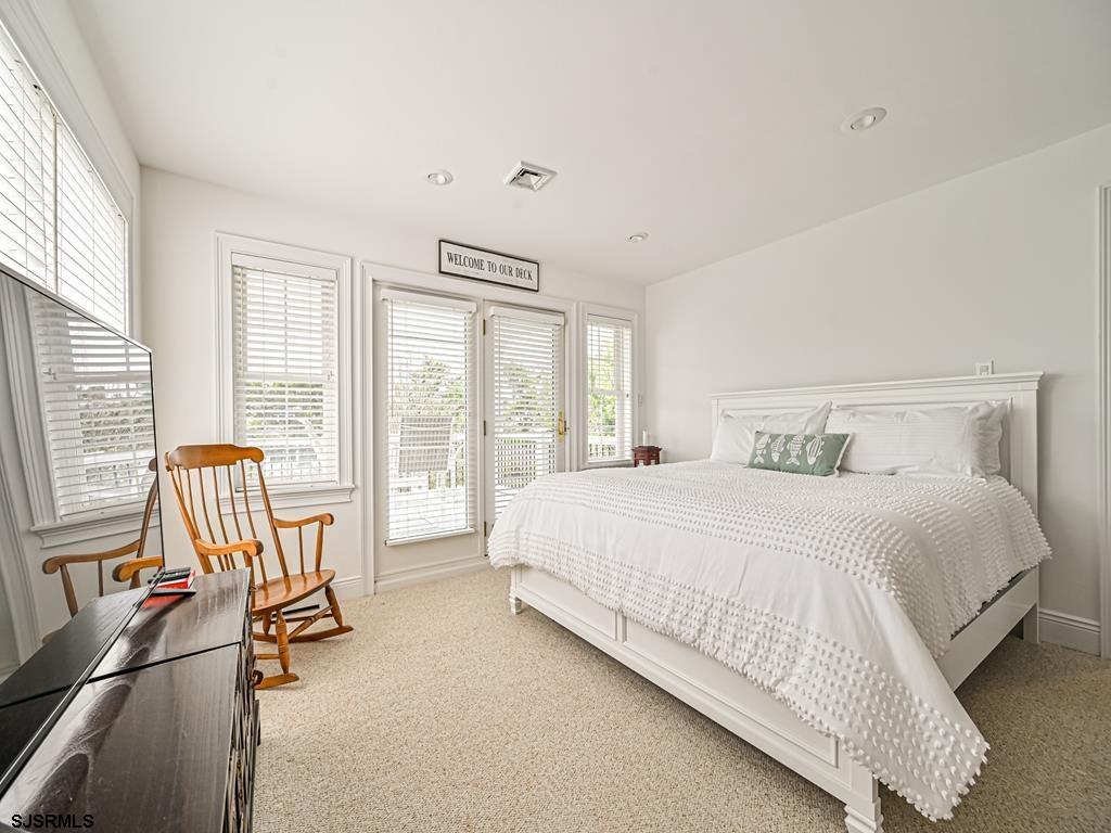 2304 Ocean Avenue Brigantine, NJ 08203 - Photo 20 of 27 a bedroom with a bed and a large window with outer view